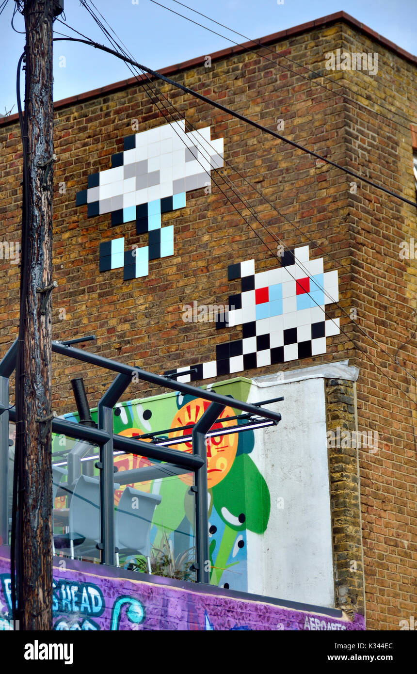 London, England, UK. Mosaic Street art by 'Invader' (French urban artist, b1969) in Camden Town Stock Photo