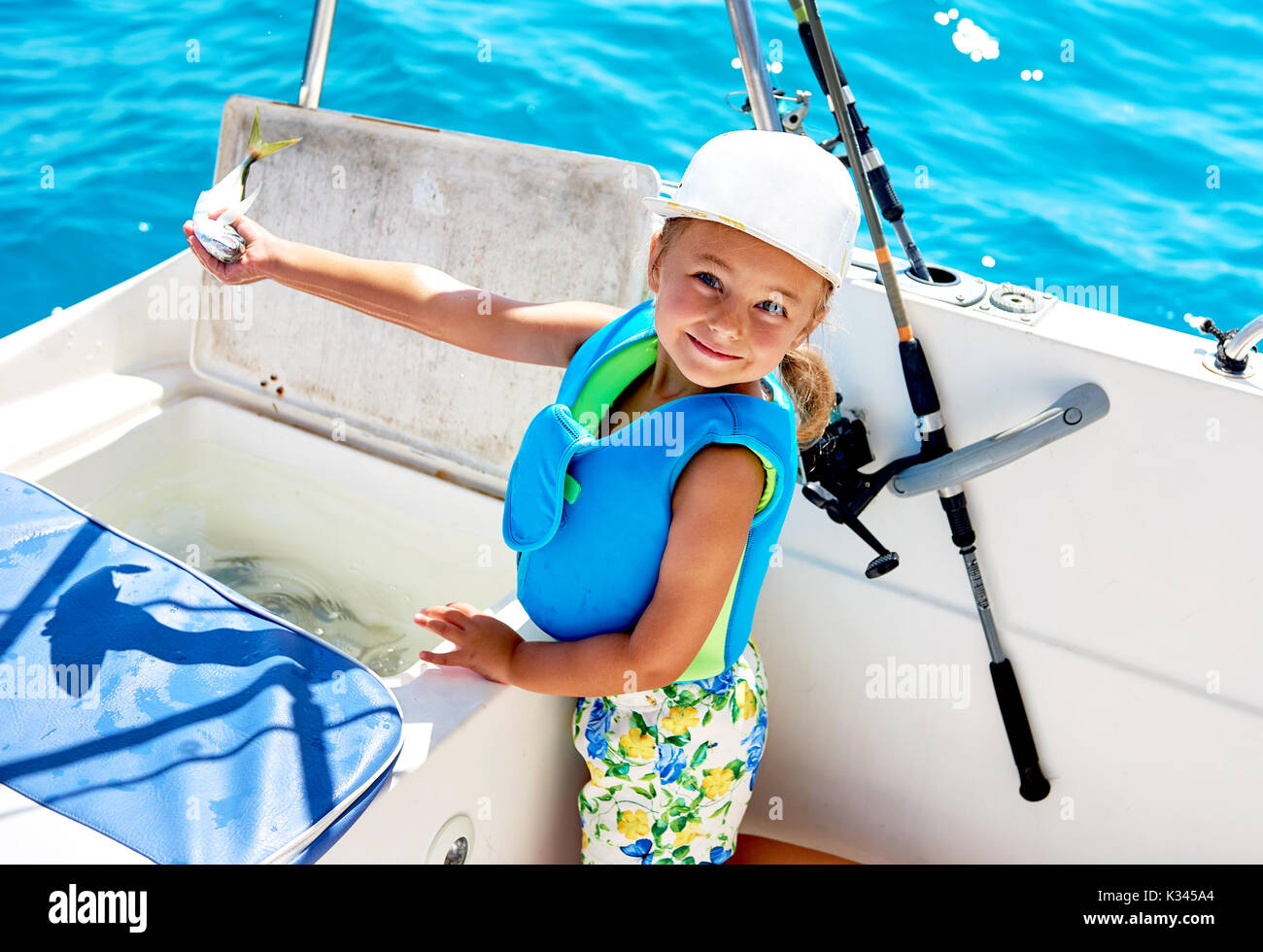 Happy little girl holding fish hi-res stock photography and images - Alamy