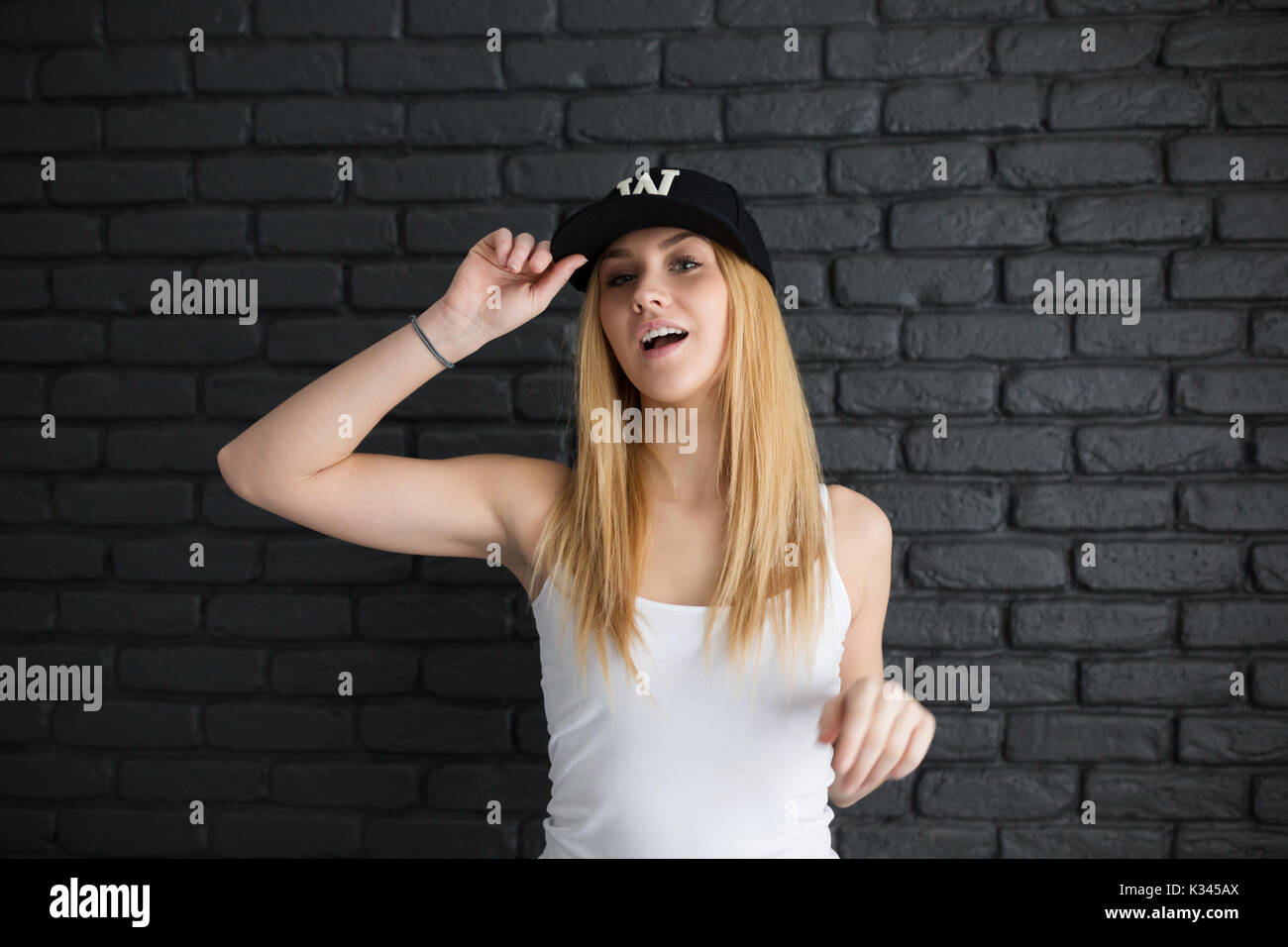 A photo of young, beautiful woman in sports clothes, full of energy and happiness. Stock Photo