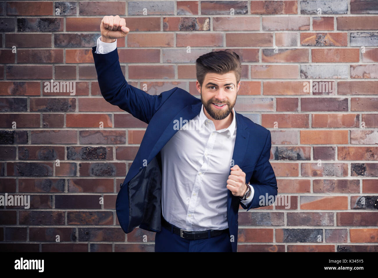 A photo of young, successful man wearing navy suit. Stock Photo