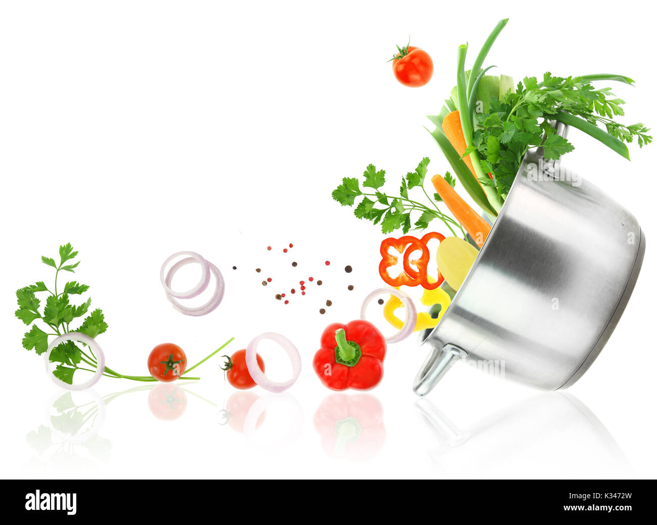 Fresh vegetables coming out from a stainless steel casserole pot Stock Photo