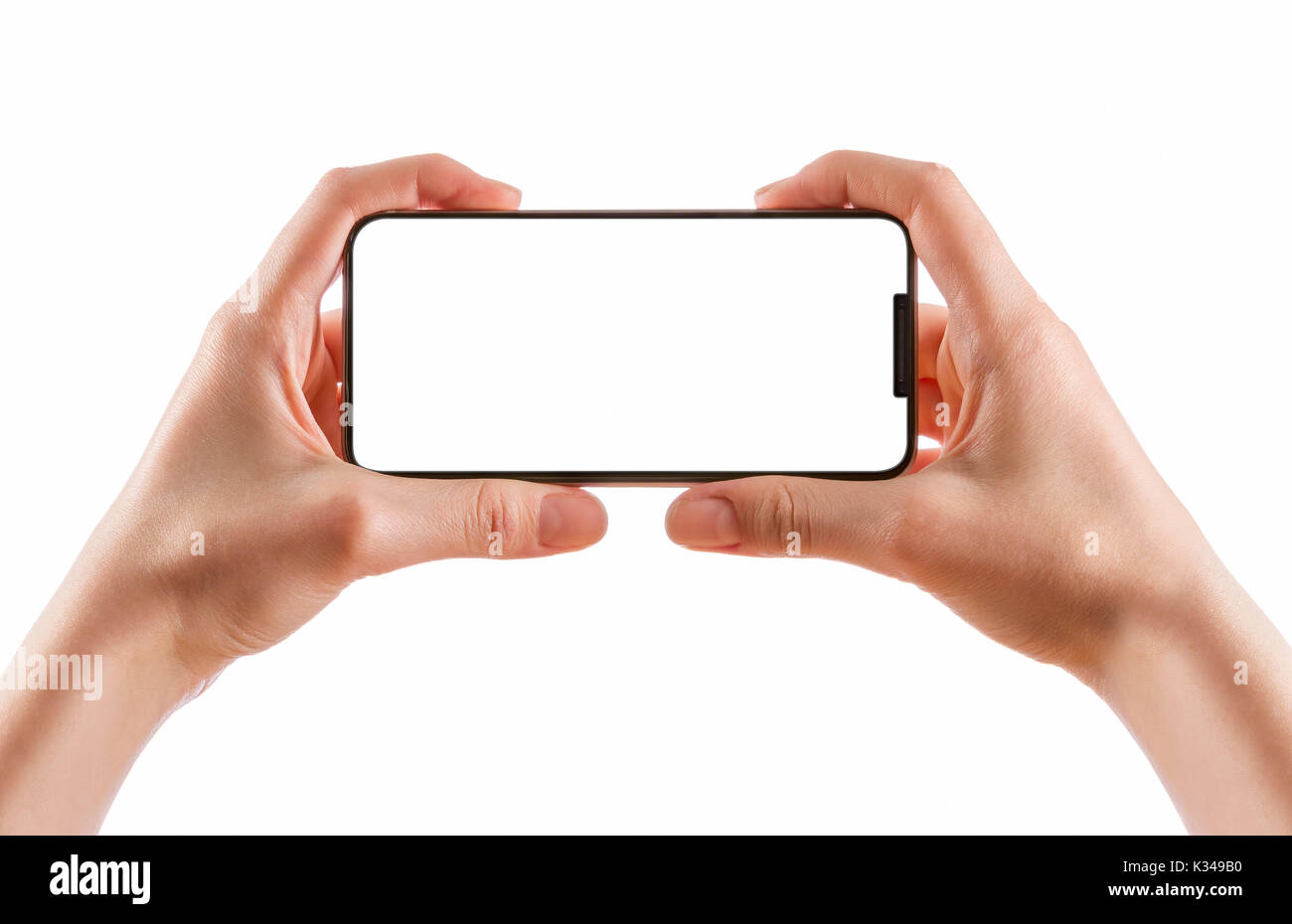 Young girl hands holding black smart phone isolated on white clipping path inside. Stock Photo