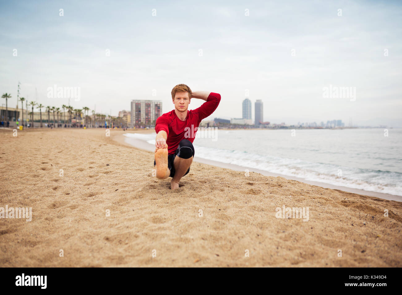 Focused young man stretching hi-res stock photography and images - Alamy