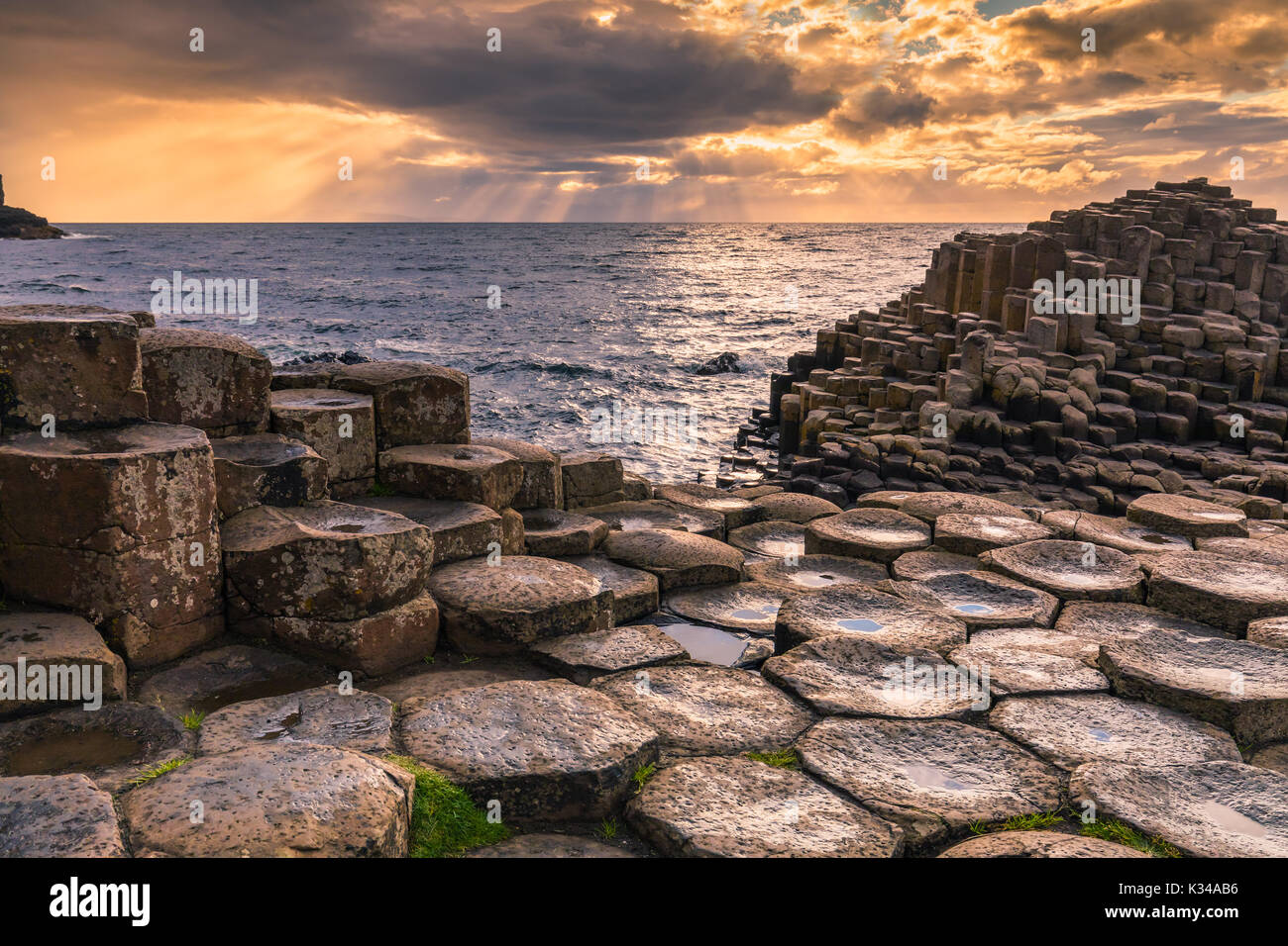 The Giant's Causeway is an area of about 40,000 interlocking basalt columns, the result of an ancient volcanic eruption. It is located in County Antri Stock Photo