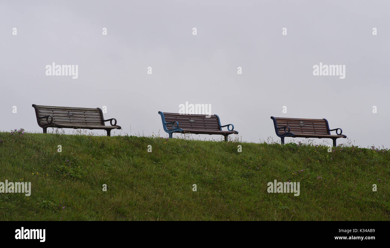 Empty seaside seats overlook the Solent on an overcast day. Portsmouth. Hampshire, UK. Stock Photo