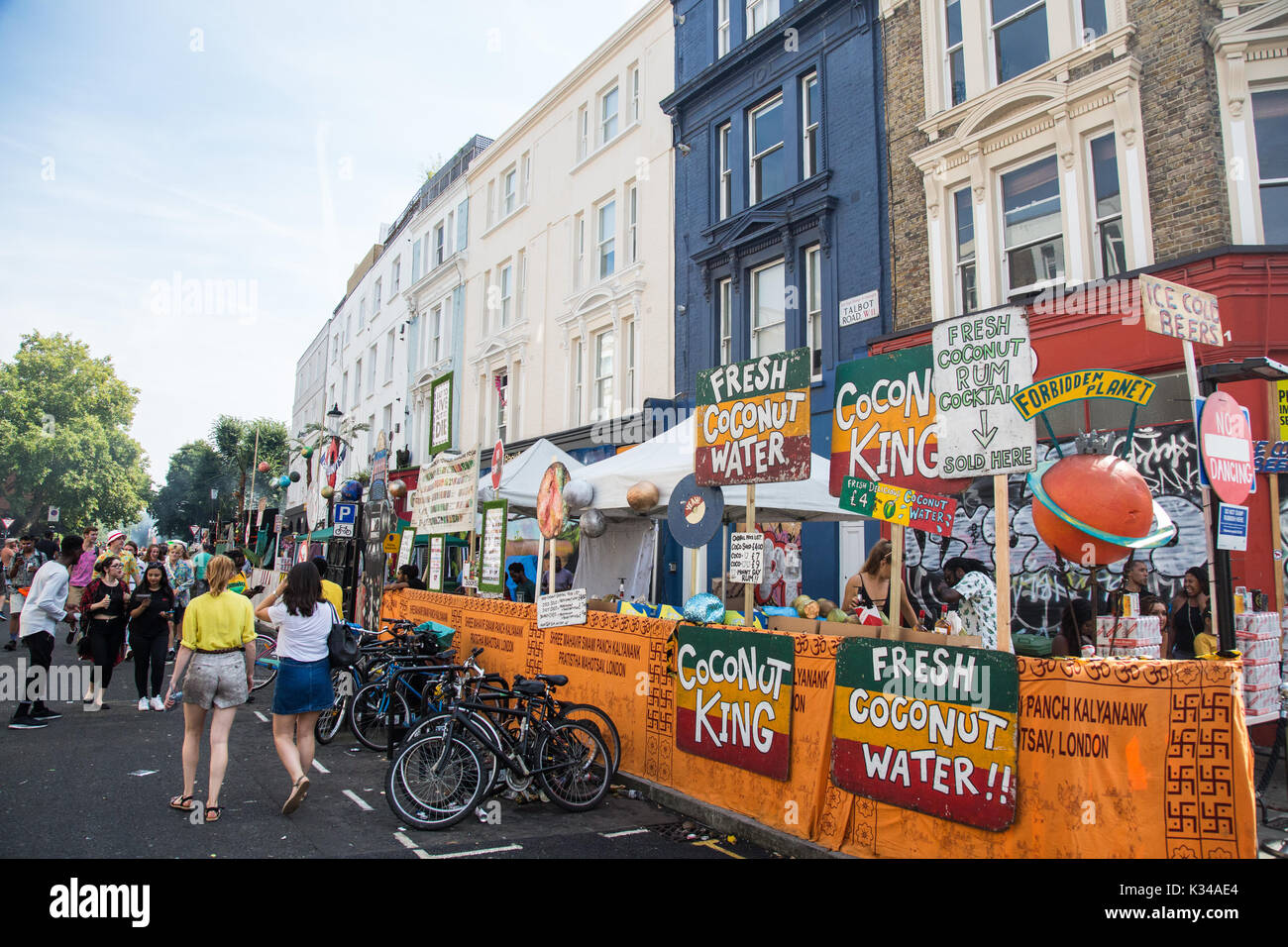 London, UK. 28th August, 2017. Revellers pass food stalls and a stage