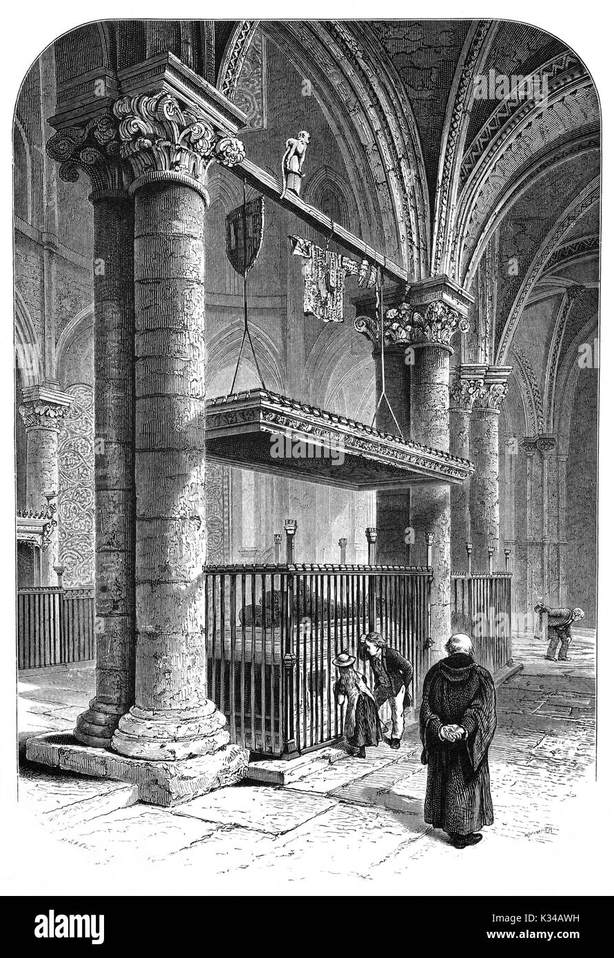 1870: Visitors and a clergyman passing the tombstone and bronze effigy of Edward of Woodstock, also known as the Black Prince in Canterbury Cathedral, Kent. The 14th prince was the eldest son of King Edward III and Philippa of Hainault and died 8 June 1376 (aged 45) in Westminster Palace, London, England. Stock Photo