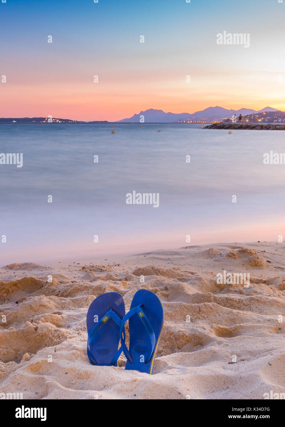 Flip flops on a sandy beach at sunset Stock Photo
