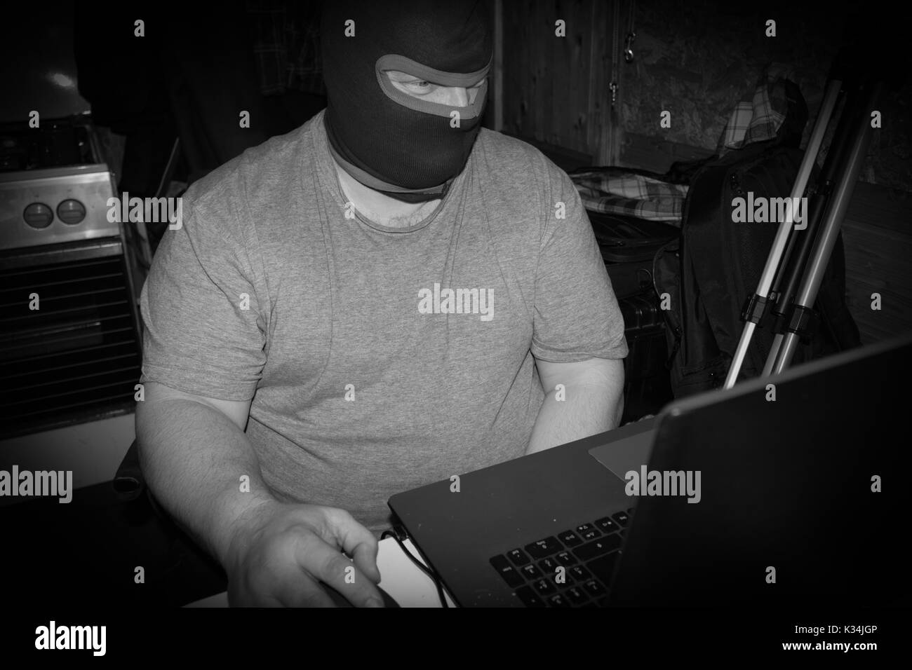 Terrorist working on his computer. Concept about international crisis, war, terrorism ,terrorist and bandit Stock Photo