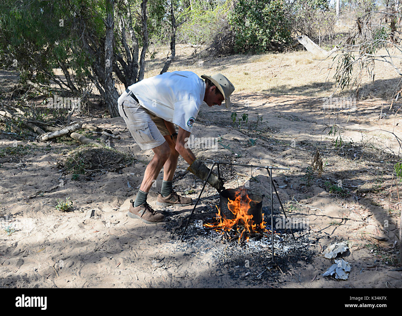 Billy For Making Tea Male with a hat boiling the billy or making tea on a campfire in the ...