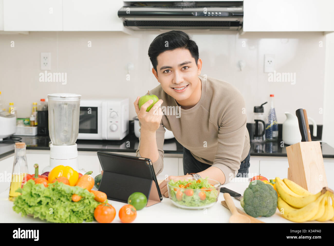 Young asian man eating apple hi-res stock photography and images - Alamy
