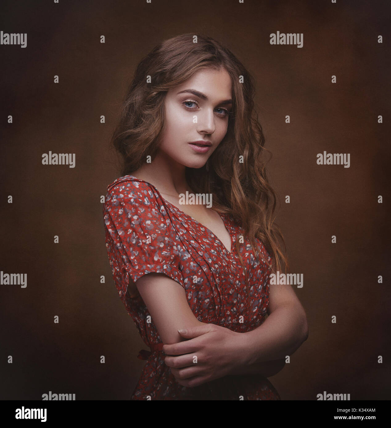 Dramatic studio portrait of a young beautiful brunette woman with long ...