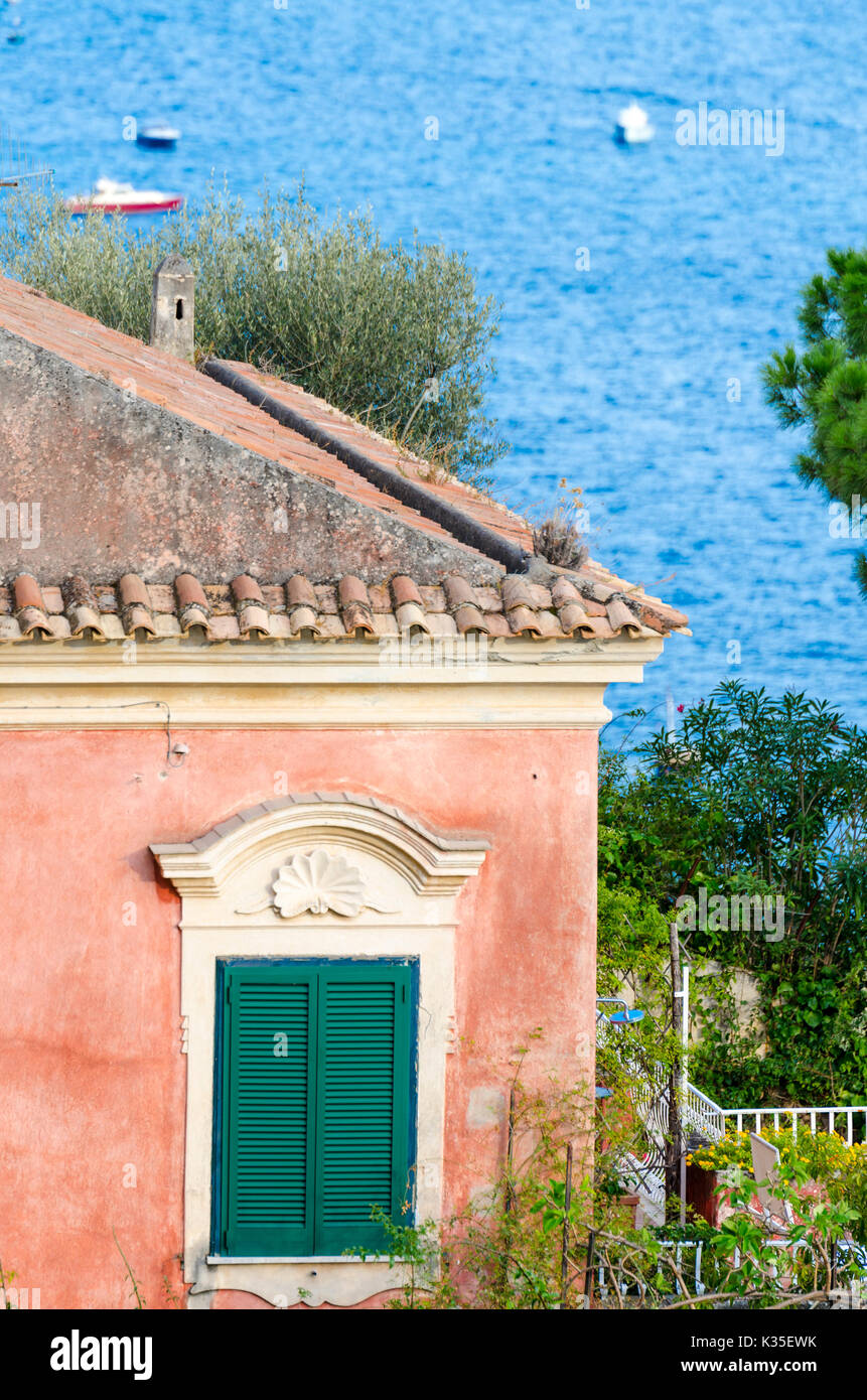 Traditional old italian house with shutters on the window overlooking the mediterranean sea. Positano, Italy Stock Photo