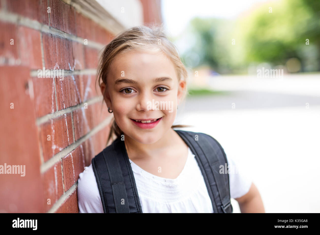 A eight years old school girl close to the schoolyards Stock Photo - Alamy