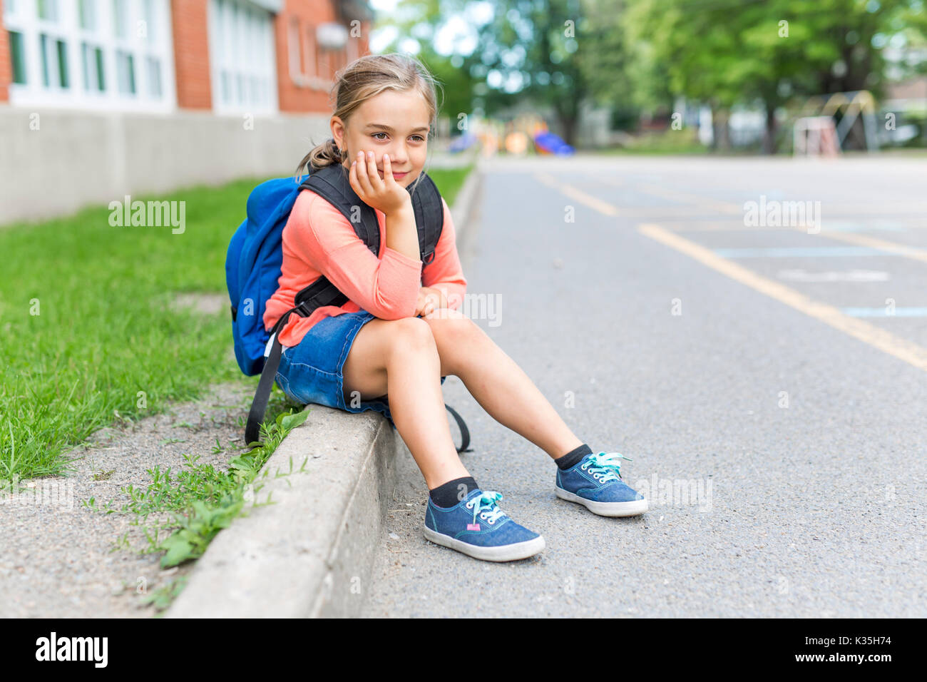 A eight years old school girl close to the schoolyards Stock Photo - Alamy