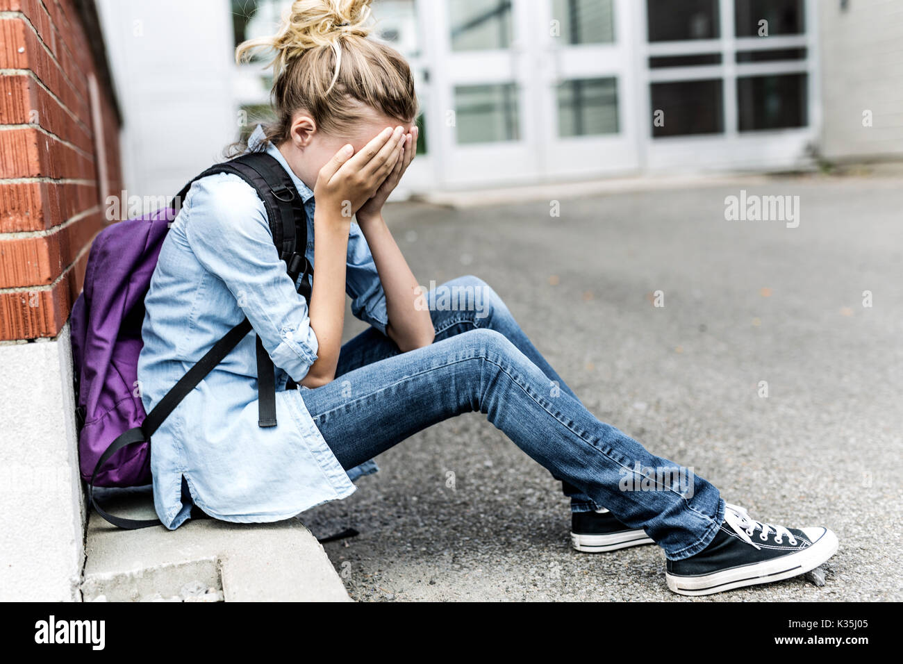 A Unhappy depress Pre teen girl at school Stock Photo - Alamy