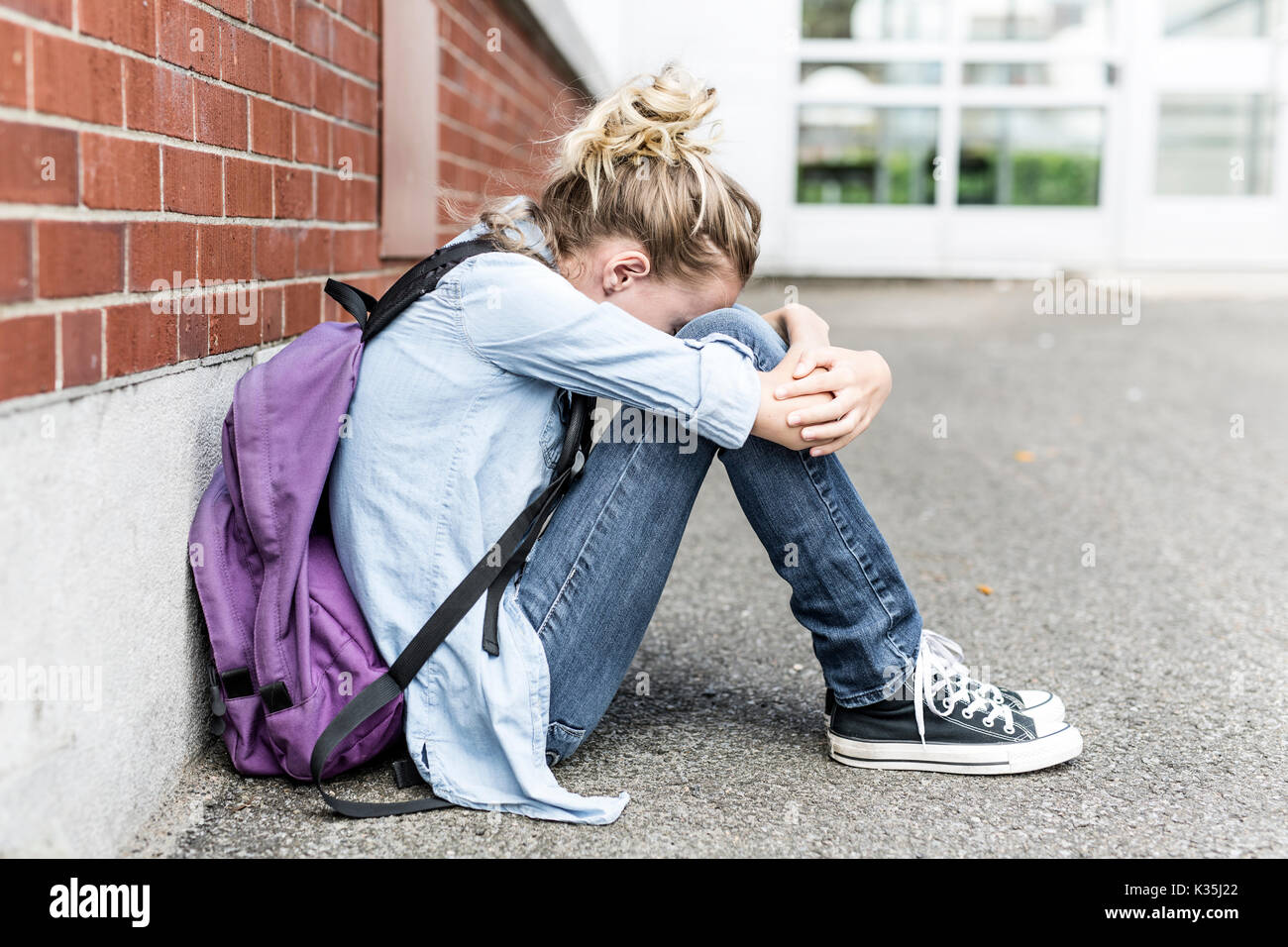 Upset girl sitting playground hi-res stock photography and images - Alamy