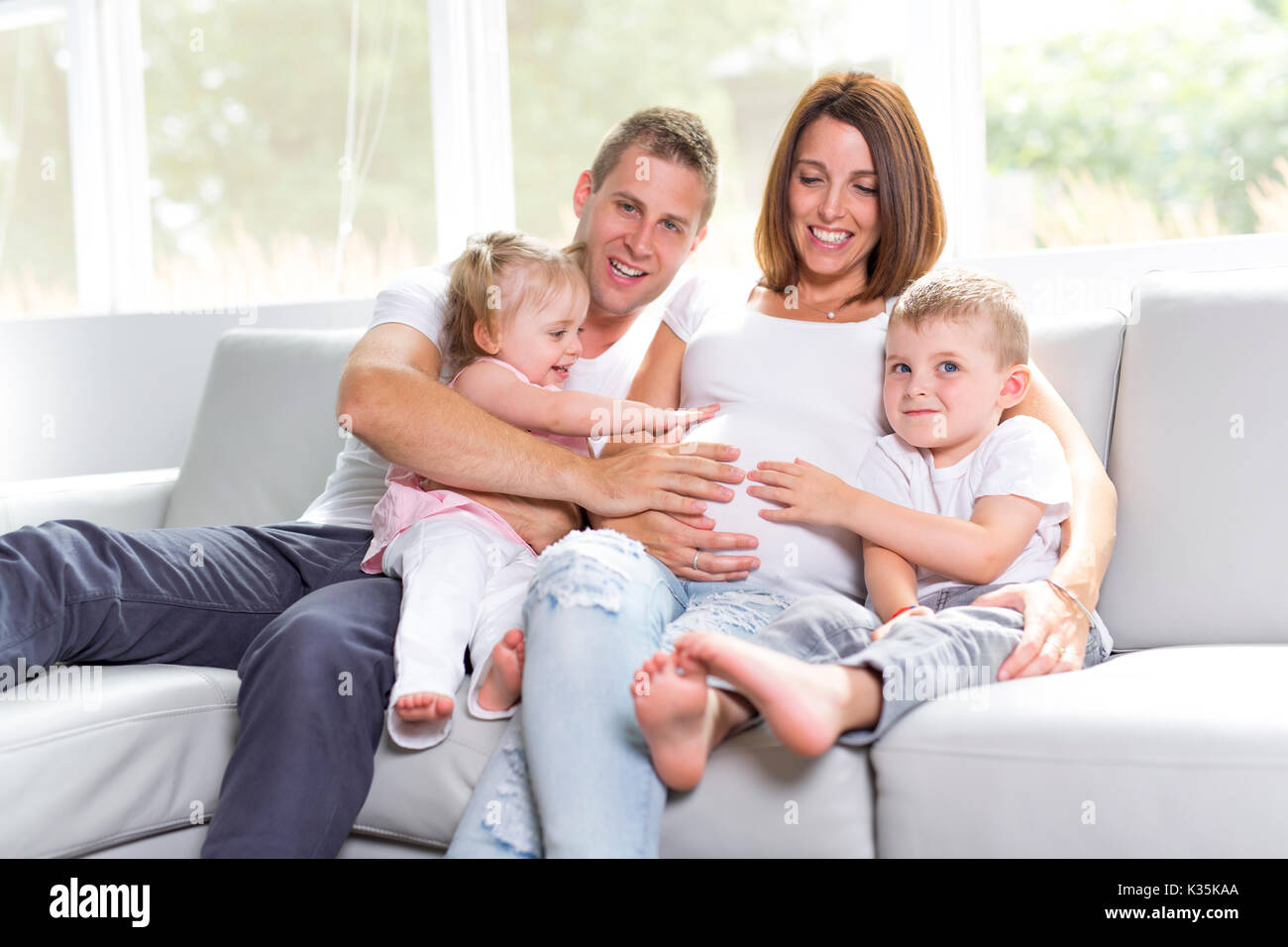 A Beautiful family portrait sitting in the living room at home Stock ...
