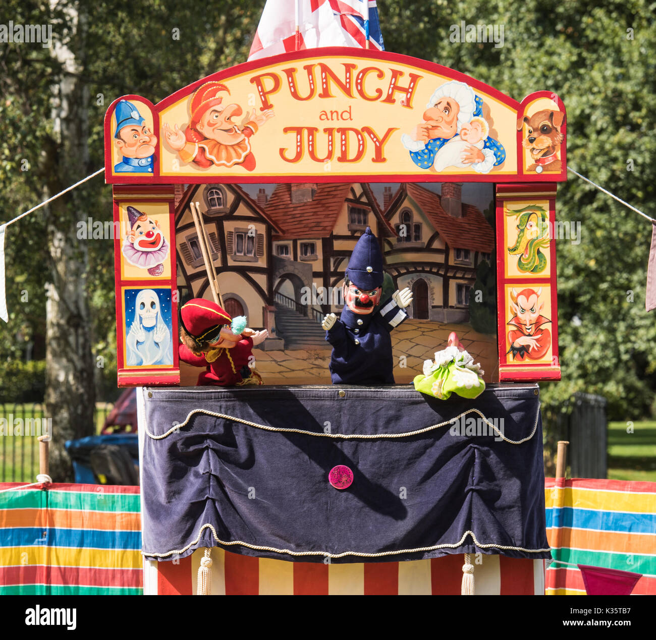 a traditional Punch and Judy show by David Wilde in an English park in the summer at Brentwood, Essex with the Mr Punch and Policeman puppets Stock Photo