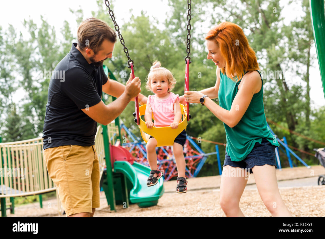 Boy and girl sharing swing on summer day in Sweden Stock Photo - Alamy