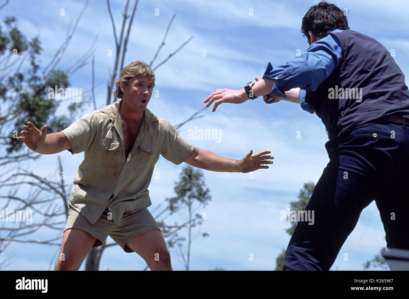 THE CROCODILE HUNTER: COLLISION COURSE STEVE IRWIN faces off with a poacher on top of a speeding vehicle in Metro-Goldwyn-Mayer Pictures adventure comedy Photo by: Frazer Bailey Stock Photo