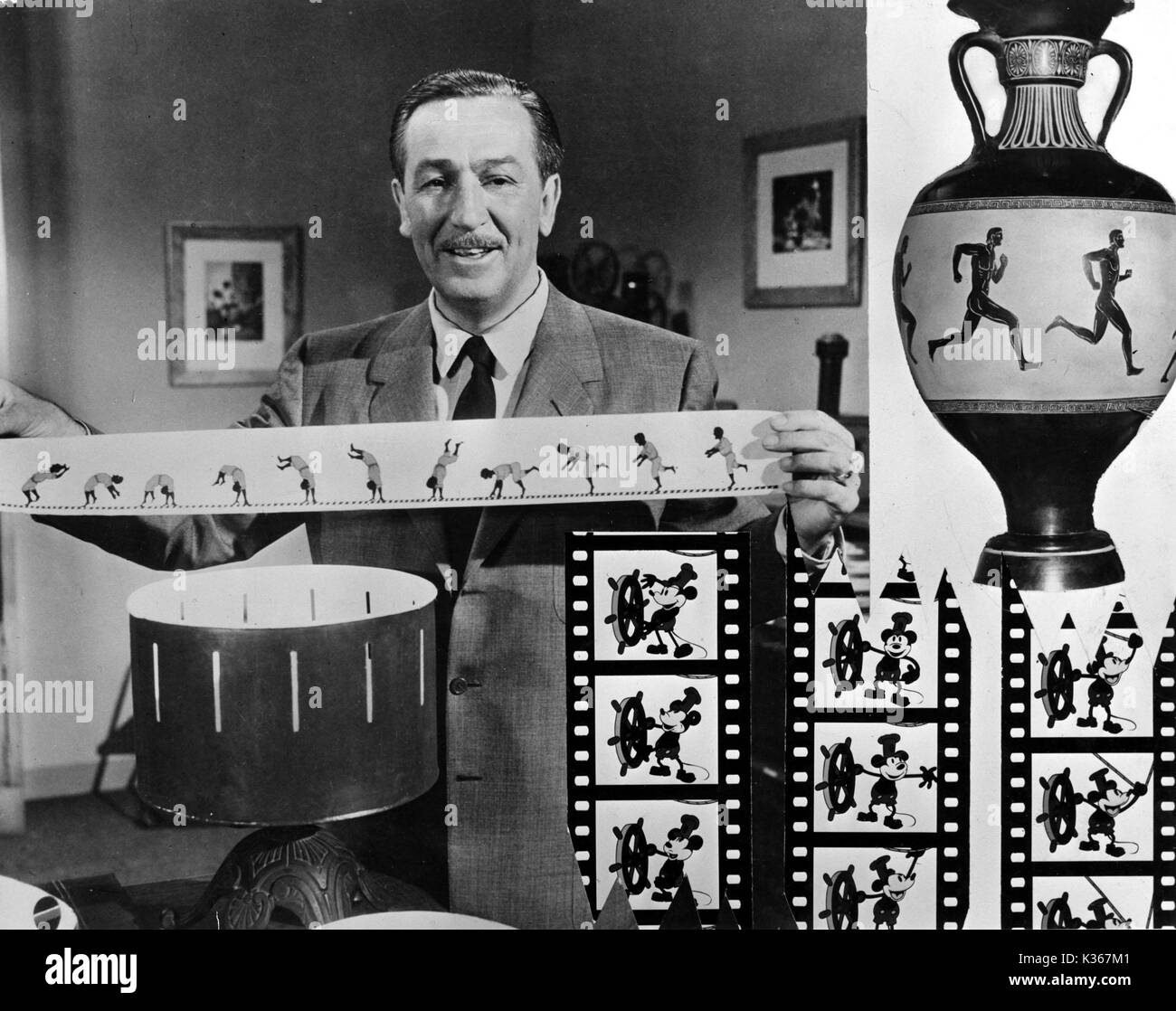 WALT DISNEY [1901 -1966] Animator, Director, Producer, Studio Executive holds a strip for a zoetrope. Inset: frames from first Mickey Mouse cartoon, 'Steamboat Willie' WALT DISNEY Stock Photo