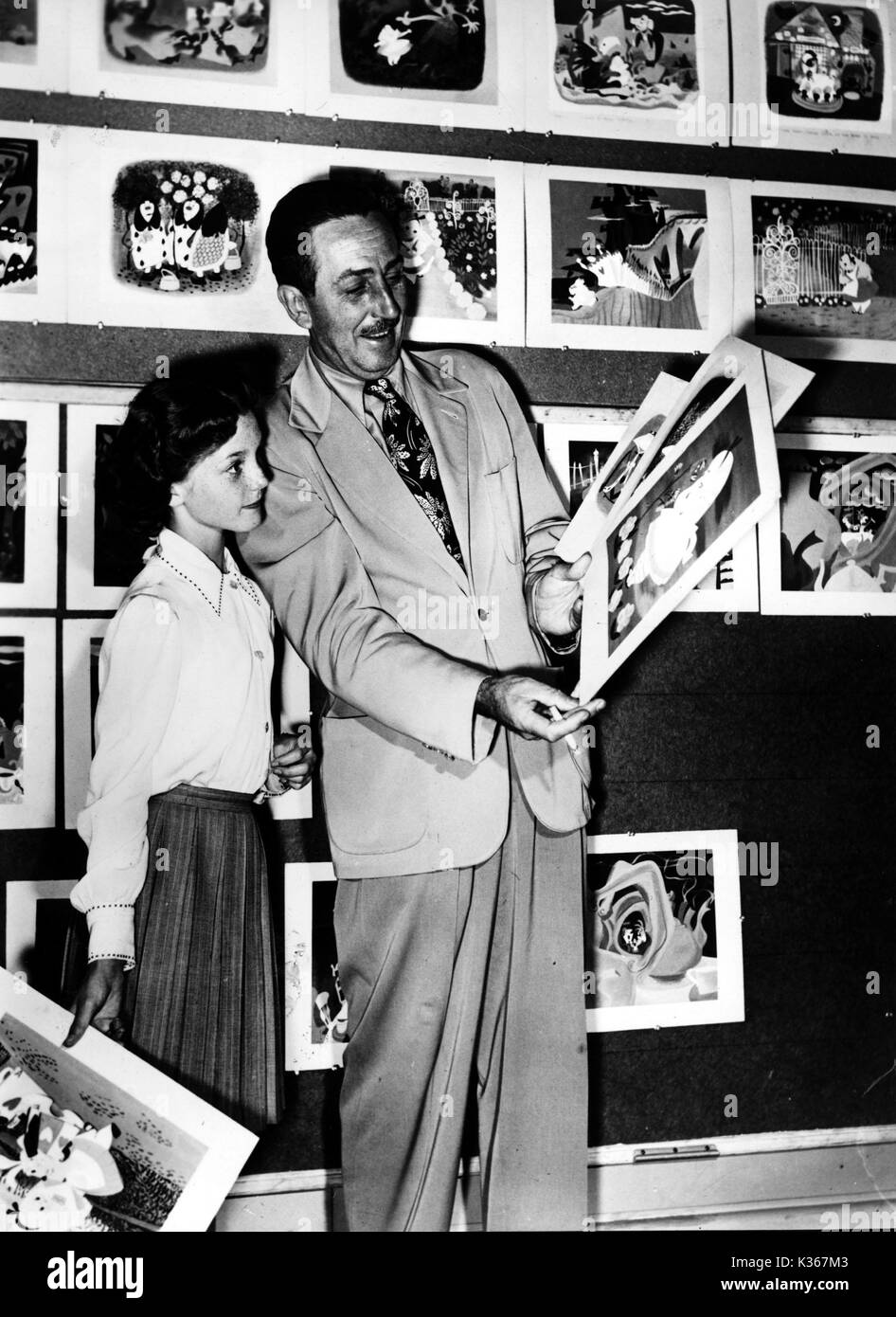 WALT DISNEY Animator, Director, Producer, Studio Executive. Disney shows cell animation and storyboards for Alice in Wonderland Stock Photo