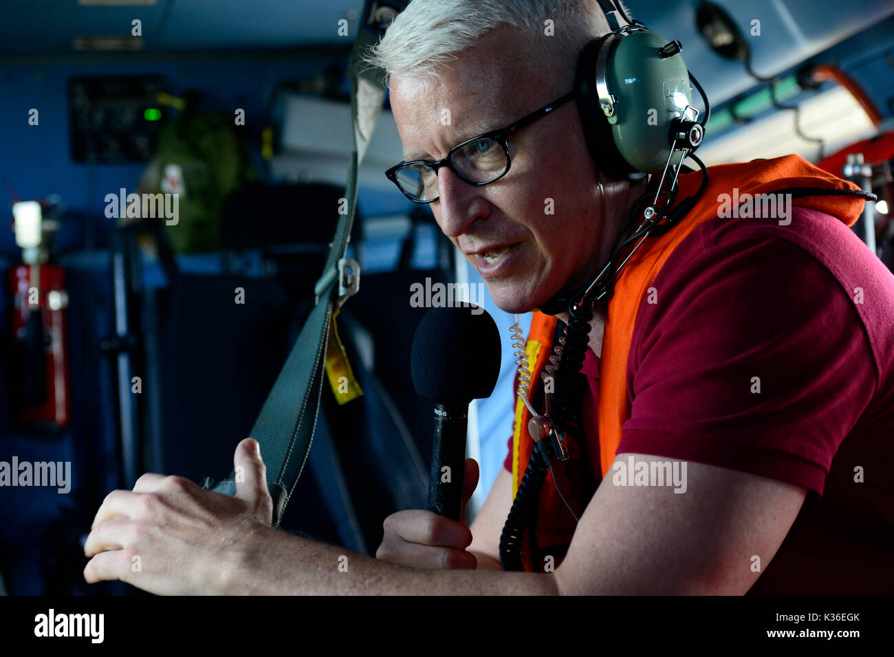 Houston, United States. 31st Aug, 2017. CNN news anchor Anderson Cooper reports live from a U.S. Coast Guard MH-60 Jayhawk helicopter during a rescue mission in the aftermath of Hurricane Harvey August 31, 2017 in Houston, Texas. Credit: Planetpix/Alamy Live News Stock Photo