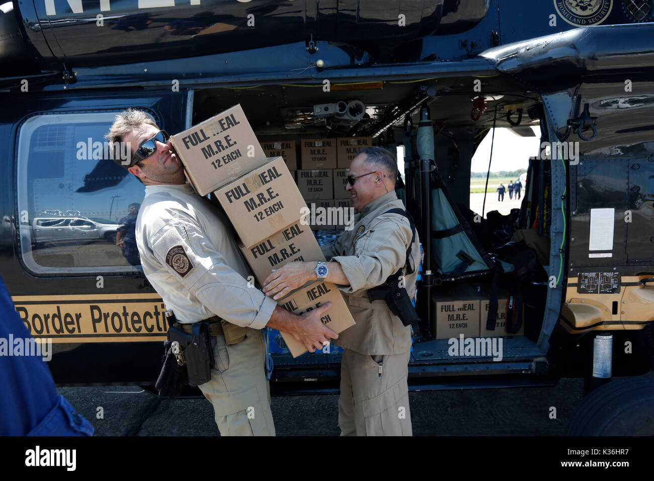 Beaumont, United States. 30th Aug, 2017. U.S CBP Air and Marine Operations aircrew unload water and packaged meals to Border Patrol Agents for distribution to residents suffering in the aftermath of Hurricane Harvey September 1, 2017 in Beaumont, Texas. Credit: Planetpix/Alamy Live News Stock Photo