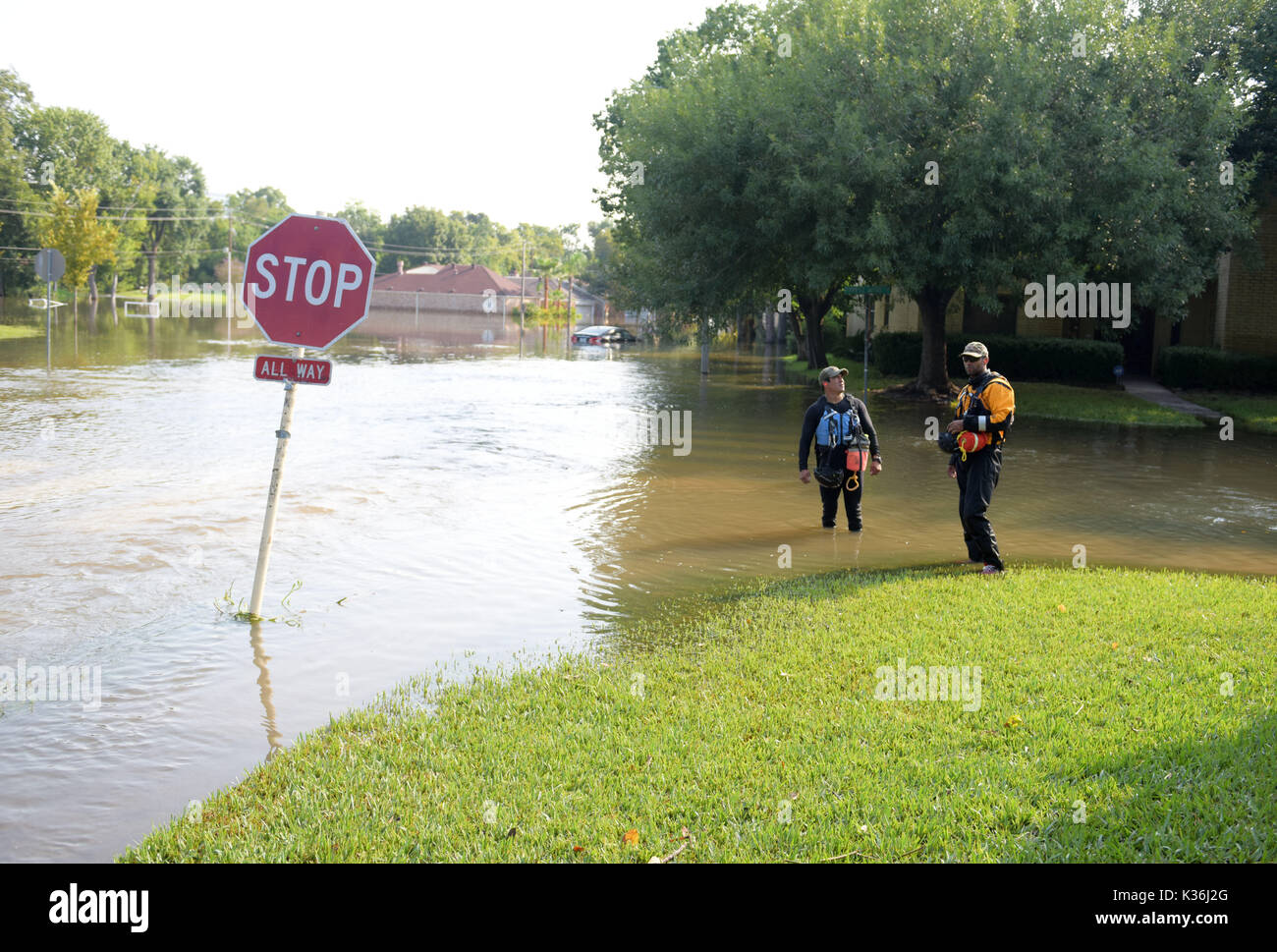 Houston, USA. 1st Sep, 2017. Rescuers stand on a flooded street near Barker Reservoir, west of Houston, Texas, the United States, Sept. 1, 2017. Heavy rain that fell following Hurricane Harvey inundated the Barker and Addicks reservoir areas, west of Houston. Since Aug. 28, the U.S. Army Corps of Engineers has been deliberately releasing water from both reservoirs into nearby neighborhoods, since rising water levels in the reservoirs reached the limits. Credit: Yin Bogu/Xinhua/Alamy Live News Stock Photo