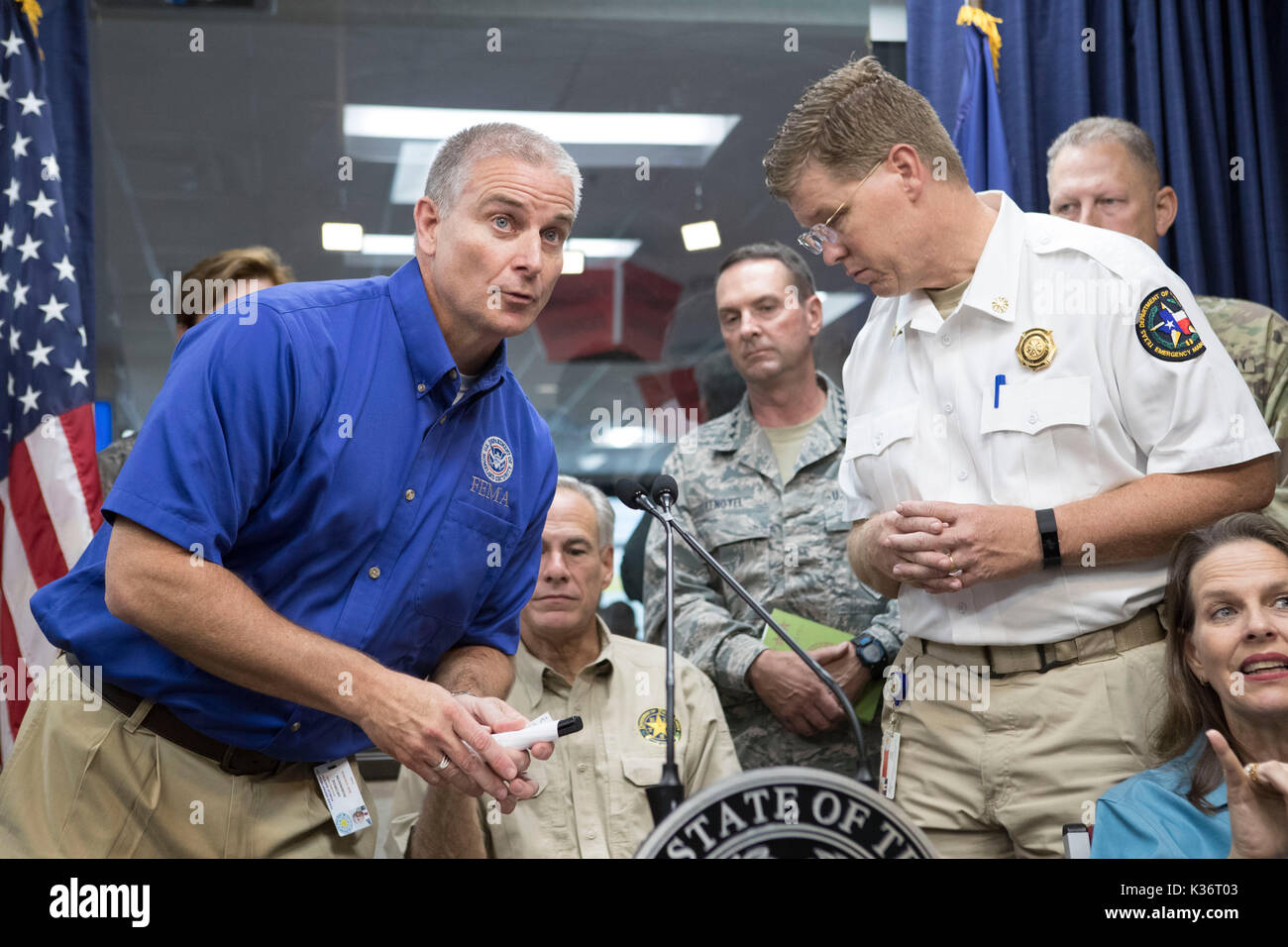 Austin, Texas USA Sept. 1, 2017: FEMA Region 6 Administrator Tony Robinson, l, speaks as Texas Gov. Greg Abbott and emergency officials continue response to extensive Hurricane Harvey damage at the Dept. of Public Safety Emergency Operations Center (EOC). Nim Kidd, chief of the Texas Division of Emergency Management, is on the right. Harvey will eventually cost the state tens of billions of dollars to recover. Credit: Bob Daemmrich/Alamy Live News Stock Photo