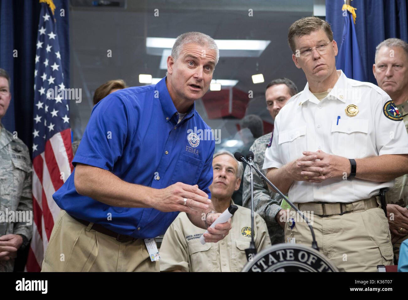 Austin, Texas USA Sept. 1, 2017: FEMA Region 6 Administrator Tony Robinson, l, speaks as Texas Gov. Greg Abbott and emergency officials continue response to extensive Hurricane Harvey damage at the Dept. of Public Safety Emergency Operations Center (EOC). Nim Kidd, chief of the Texas Division of Emergency Management, is on the right. Harvey will eventually cost the state tens of billions of dollars to recover. Credit: Bob Daemmrich/Alamy Live News Stock Photo