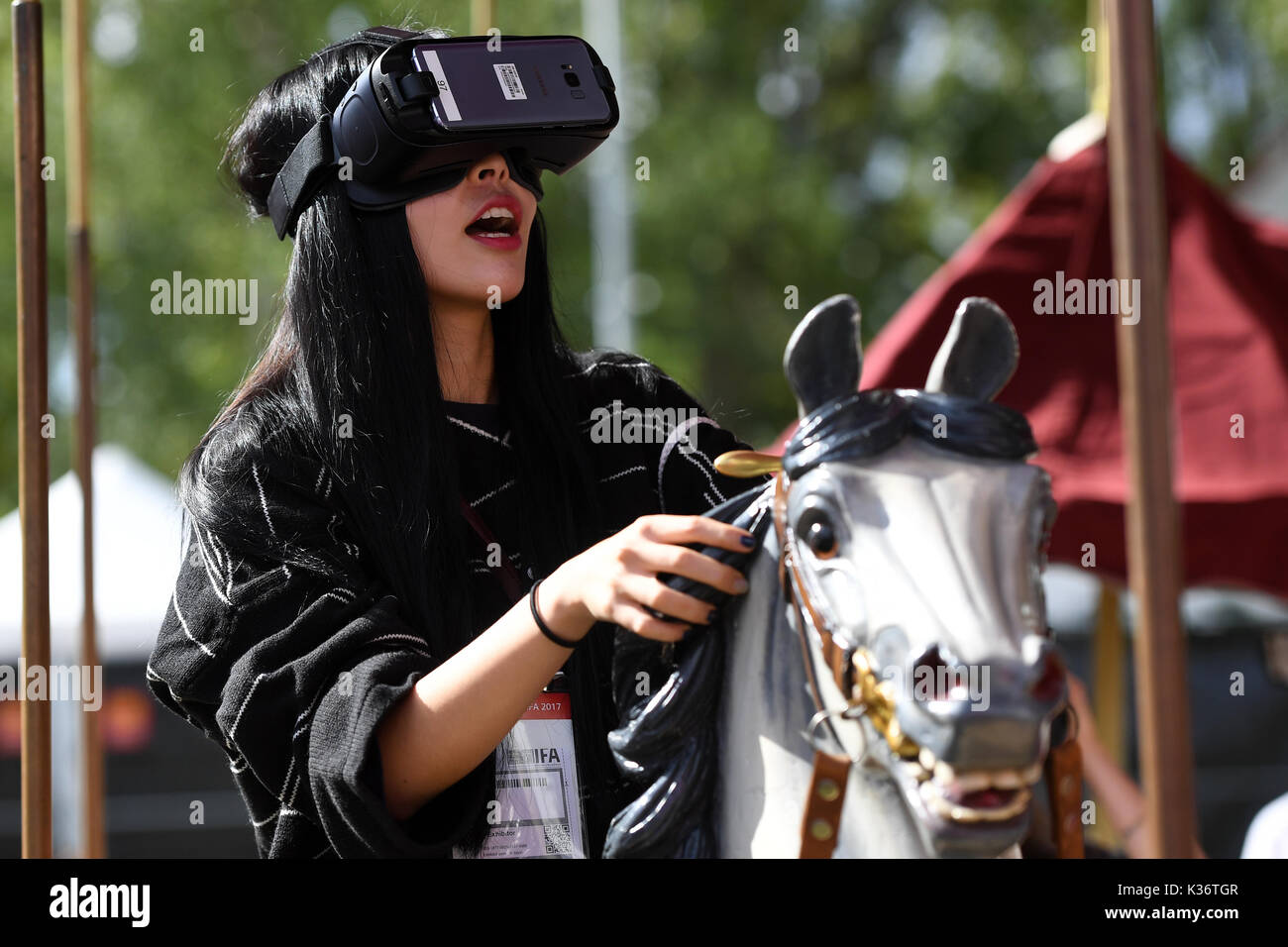 Berlin, Germany. 02nd Sep, 2017. A visitor sitting with a pair of 360 degrees glasses on a carousel at the stand of the Telecom at the electronics fair IFA in Berlin, Germany, 02 September 2017. Photo: Maurizio Gambarini/dpa/Alamy Live News Stock Photo