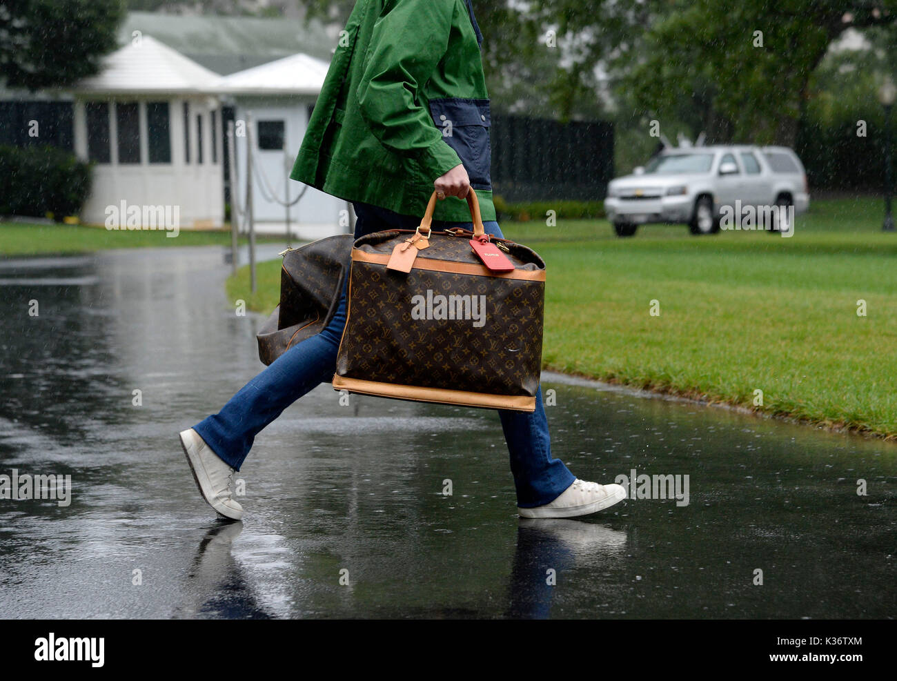 A White House aide carries Louis Vuitton bags prior to United States  President Donald J. Trump and first lady Melania Trump's departure from the  White House September 2, 2017 in Washington, DC.