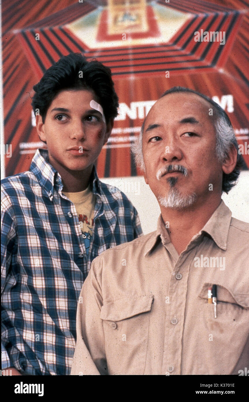THE KARATE KID Ralph Macchio as Daniel LaRusso, Pat Morita as Mr. Kesuke Miyagi COPYRIGHT: COLUMBIA     Date: 1984 Stock Photo