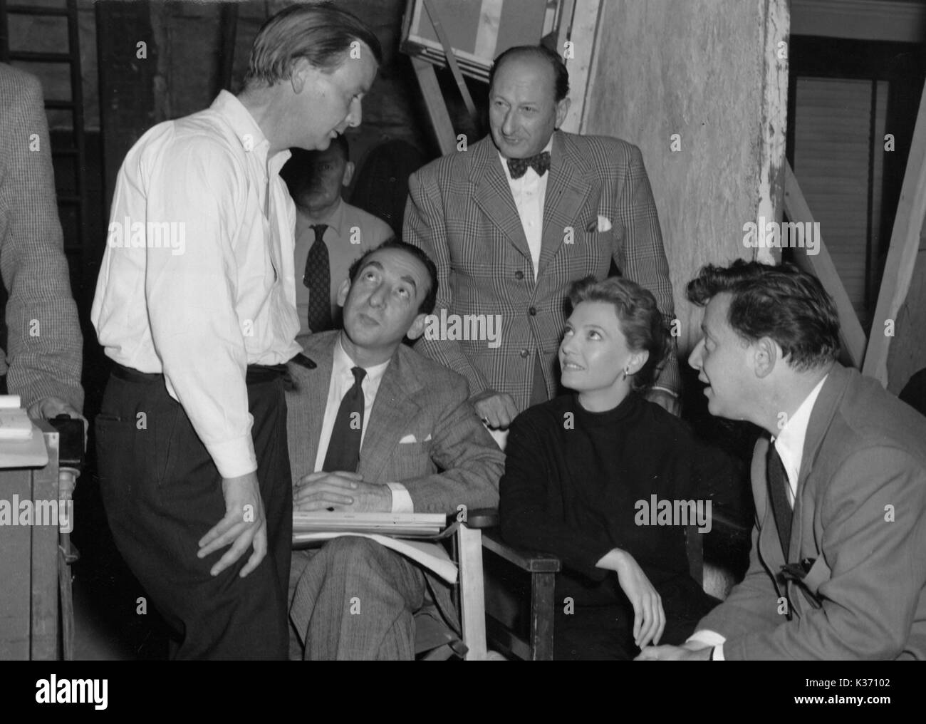 Director J Lee-Thompson, with composer Stanley Black (sitting), production manager Jack Swinburne, actress Jean Carson and producer Raymond Stross on the set of As Long as They're Happy made in 1955 Stock Photo