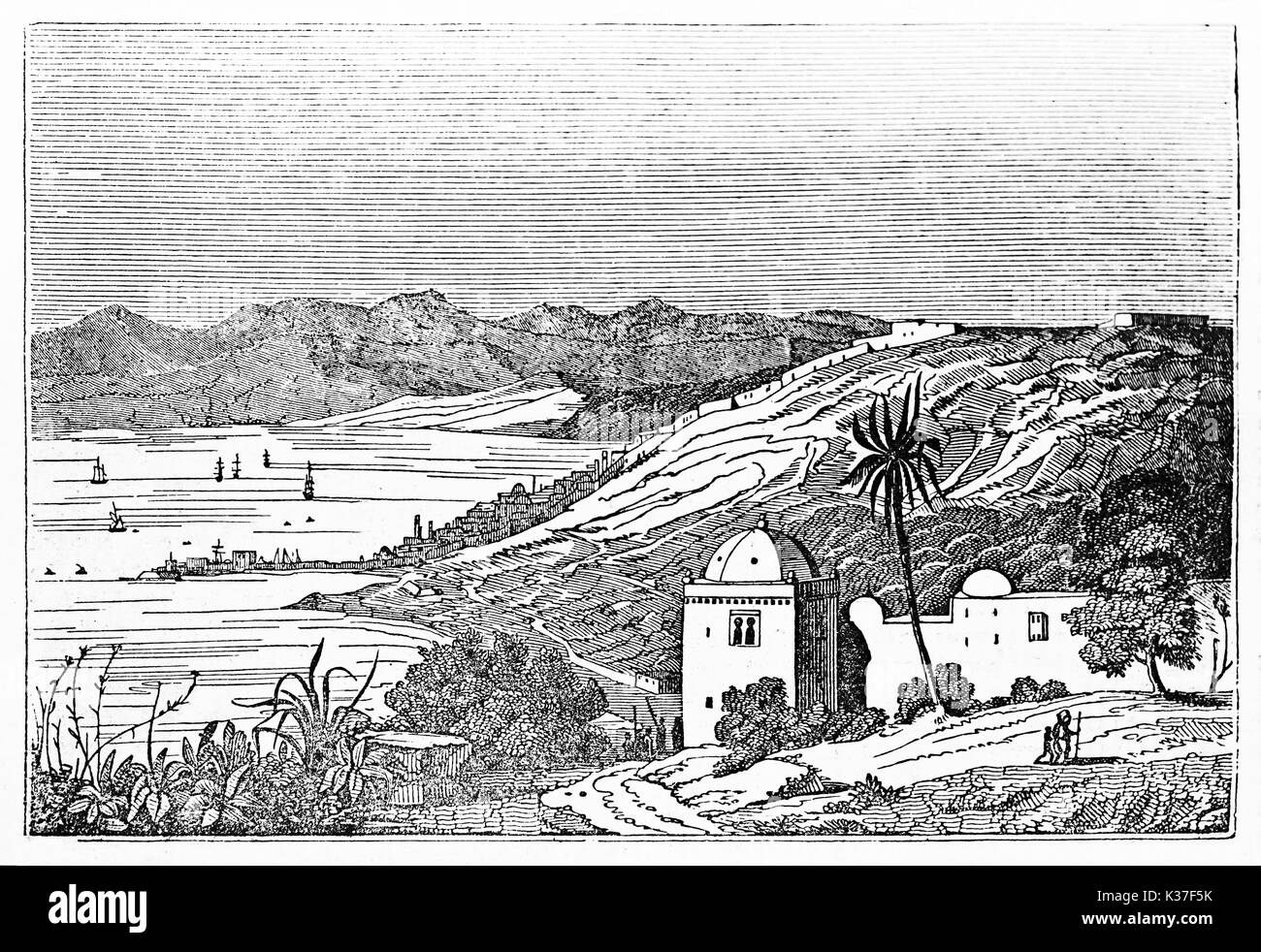 Overall ancient view of Algiers bay with arabian building in foreground, hills, little town and Mediterranean Sea in background. By unidentified author published on Magasin Pittoresque Paris 1834 Stock Photo