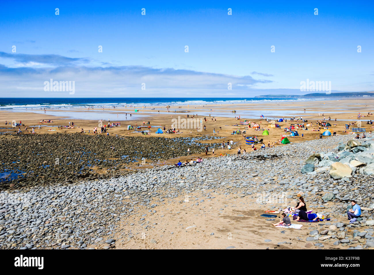 Holidaymakers head to the beach to cool off in the sea as temperatures rise, Westward Ho!, Devon, UK Stock Photo