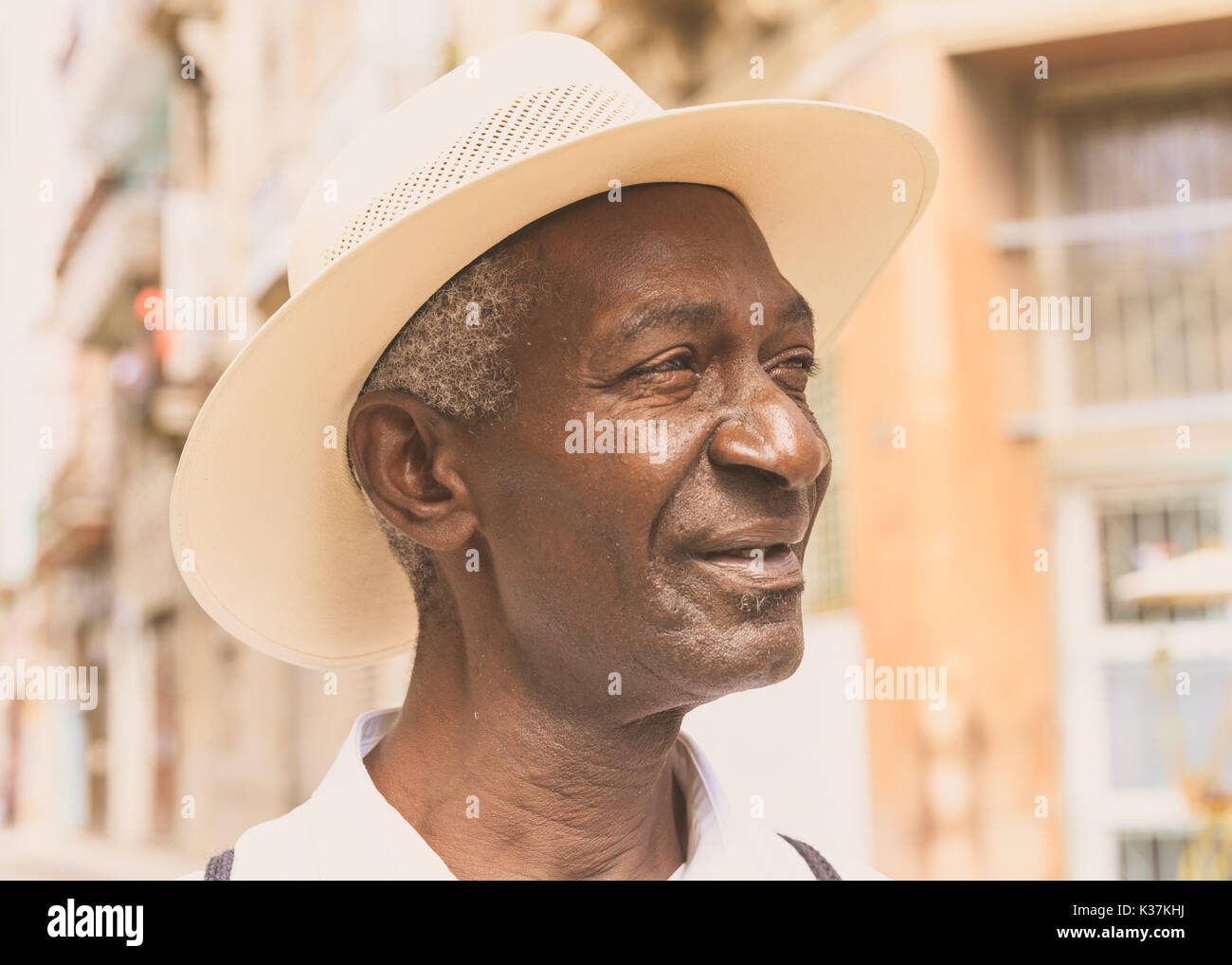 Black Afro-Caribbean Cuban male, closeup portrait, with fedora hat in afternoon sunlight, Old Havana, Cuba Stock Photo