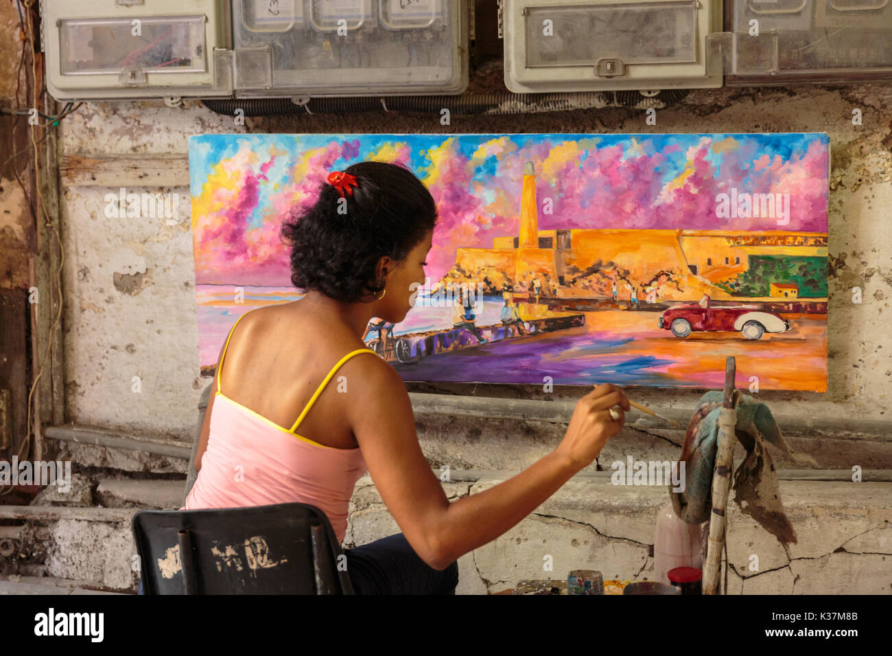 Artist working on a painting in her studio in Habana Vieja, Havana Cuba Stock Photo