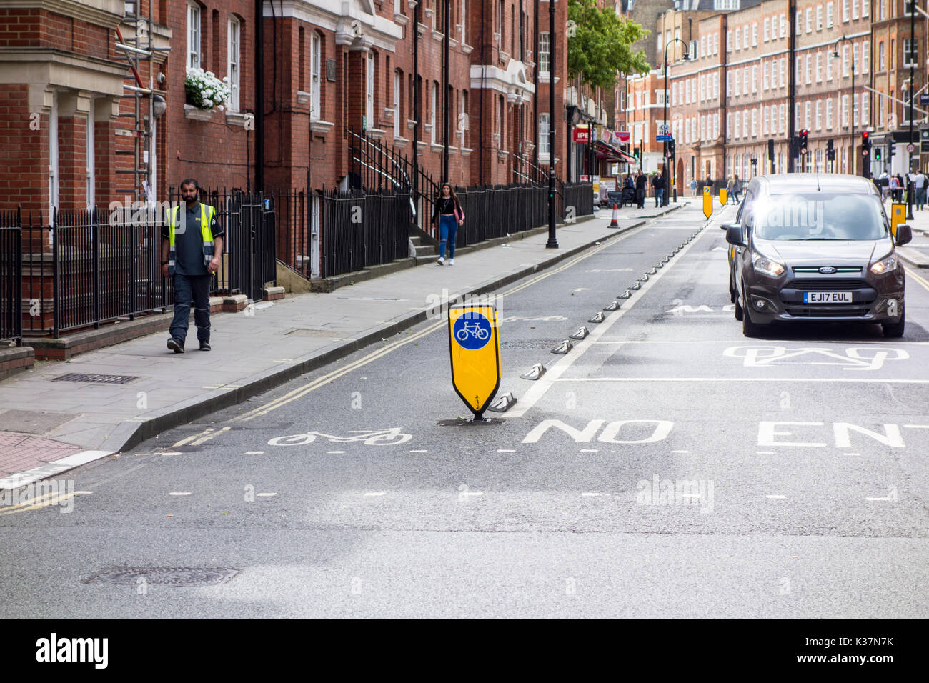 Segregated cycle lane on a London street using road studs separating cyclists from traffic Stock Photo