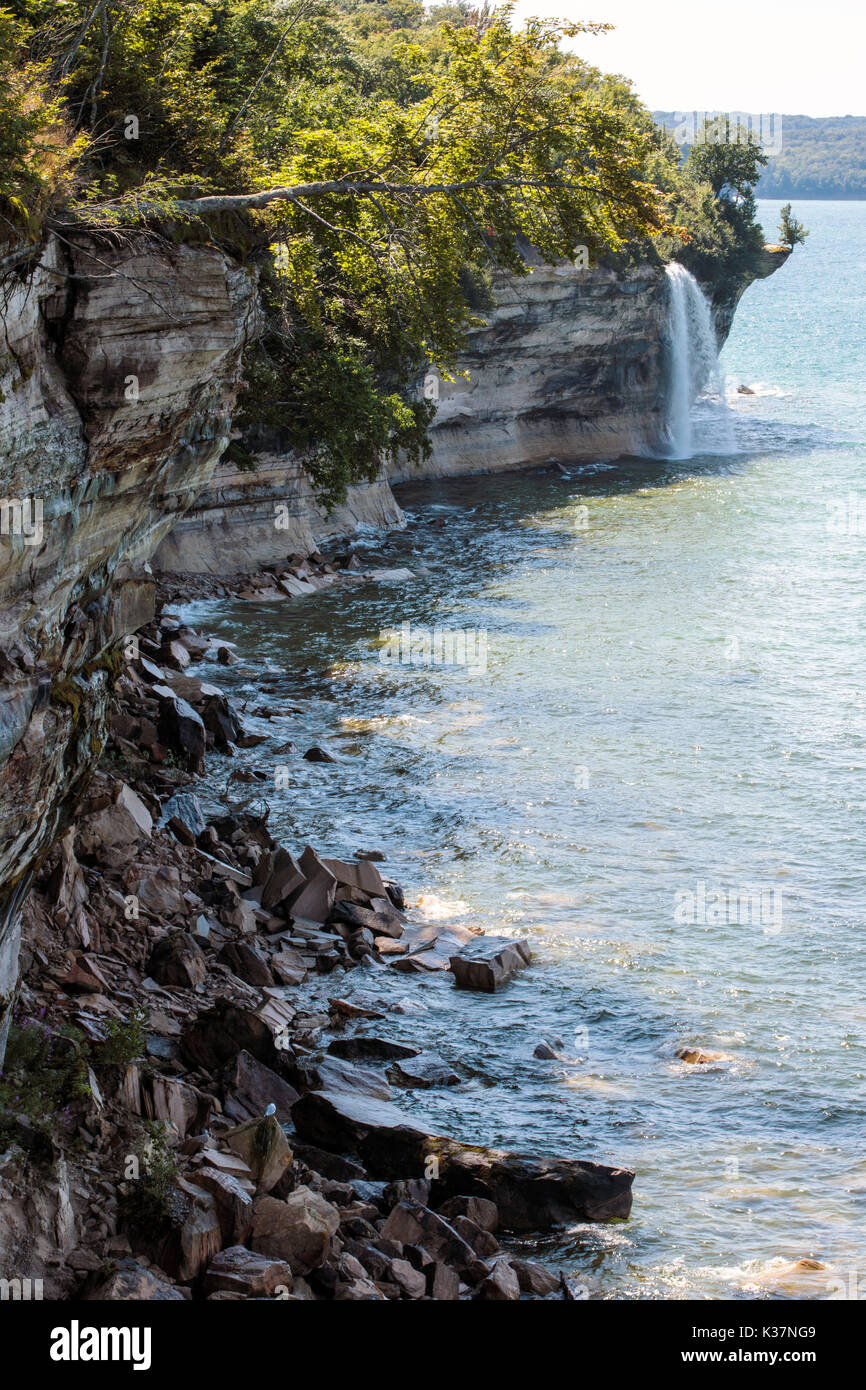 Spray Falls cascades over Pictured Rocks National Lakeshore and empties into Lake Superior, in the Upper Peninsula of Michigan Stock Photo
