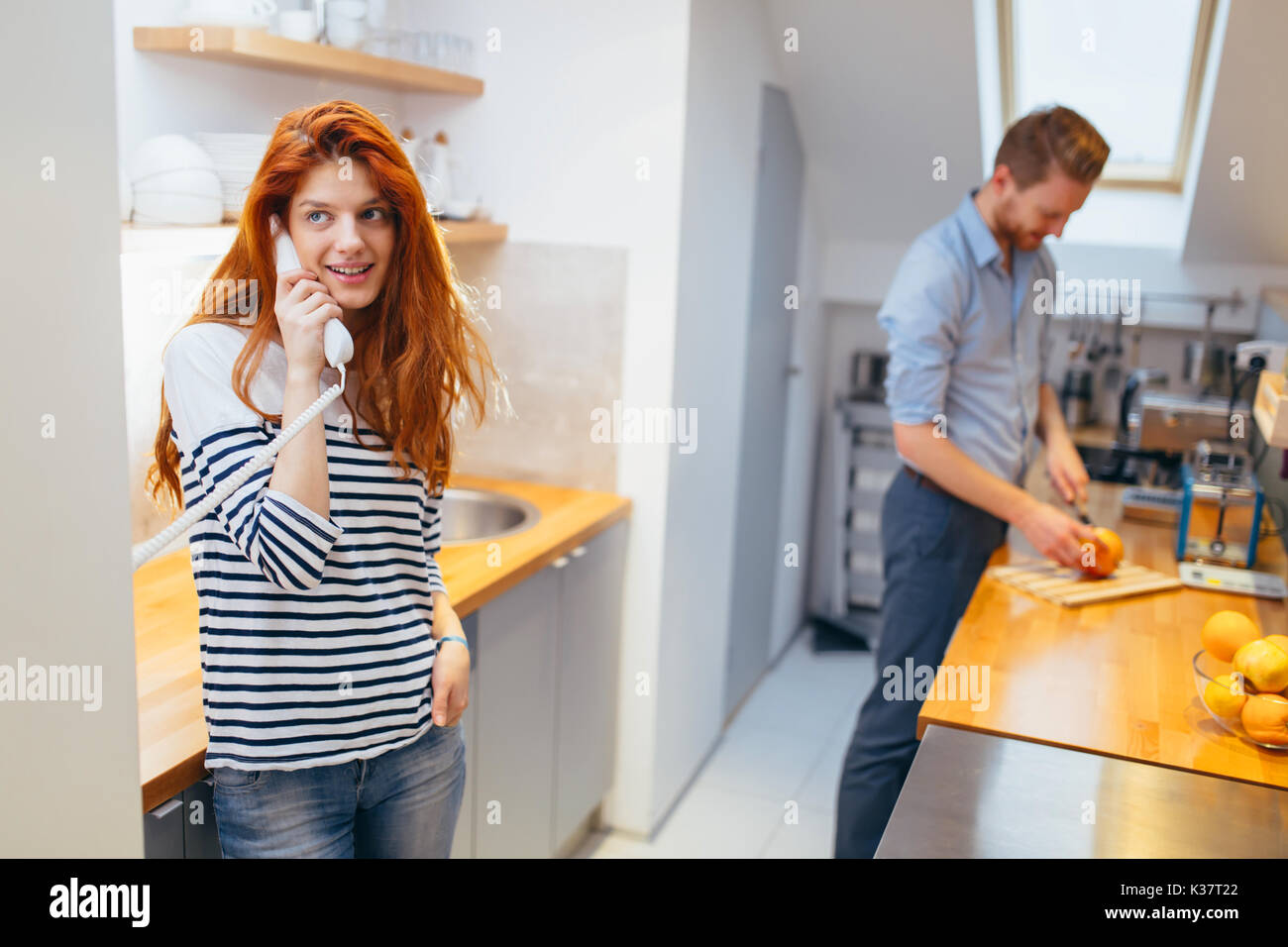 Woman talking to arriving guests on intercom Stock Photo