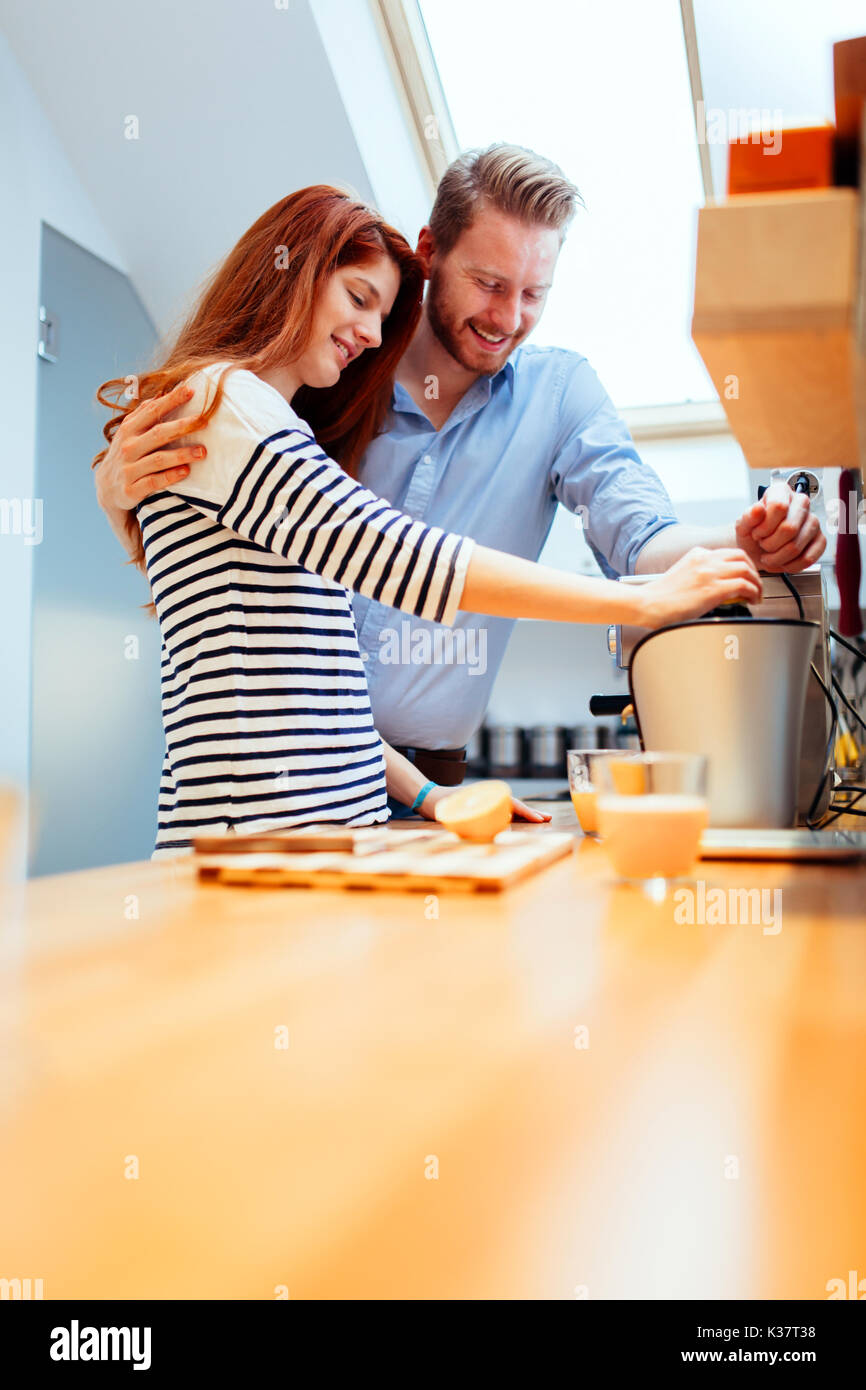 Husband and wife making orange juice Stock Ph