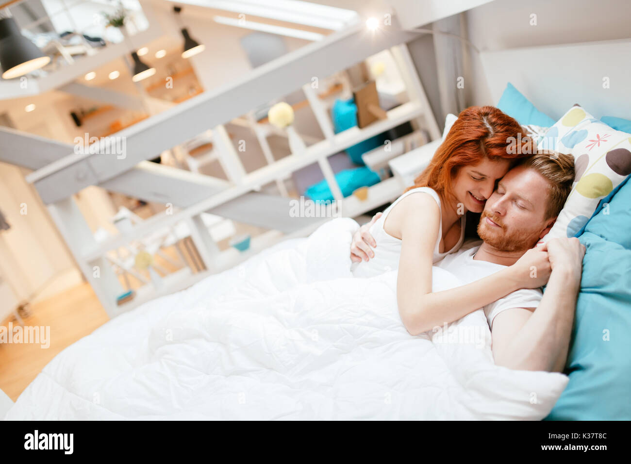 Romantic couple in love lying on bed Stock Photo
