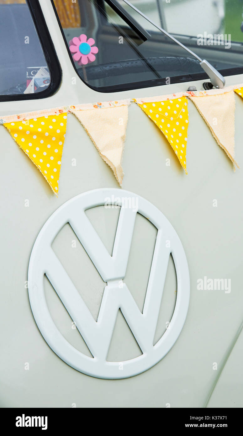 1950s VW split screen campervan front end and yellow bunting at a vintage retro festival. UK Stock Photo