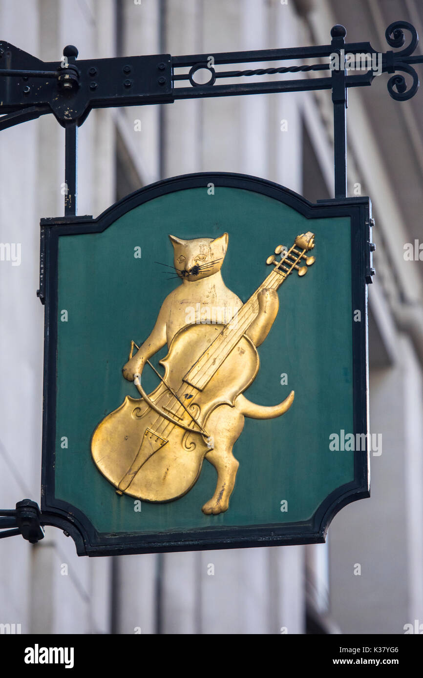 A vintage ornate sign for the former Cat and Fiddle Inn, located on Lombard Street in London, UK. Stock Photo