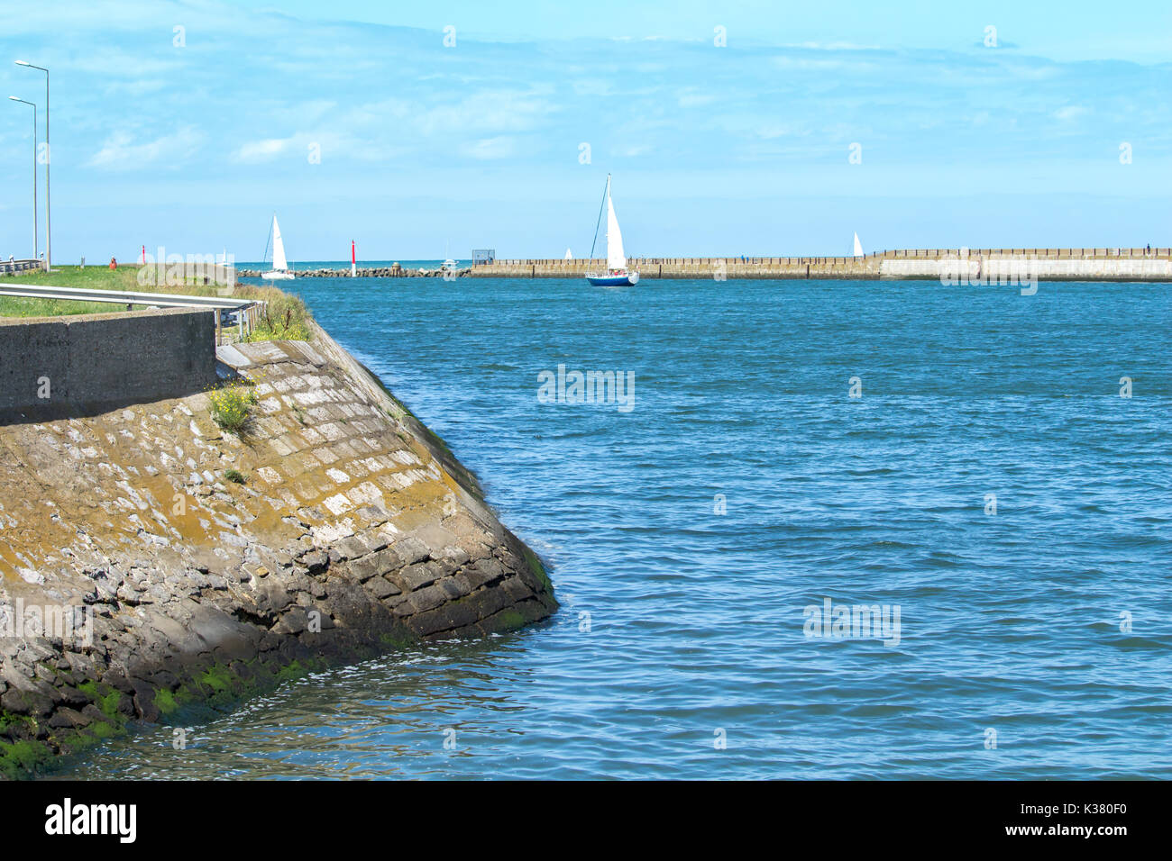 Channel of the marina of  Dunkirk near the beach with sailing ships Stock Photo