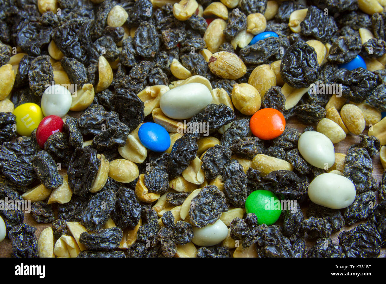 Close up abstraction of trail mix with raisins, peanuts, yogurt covered