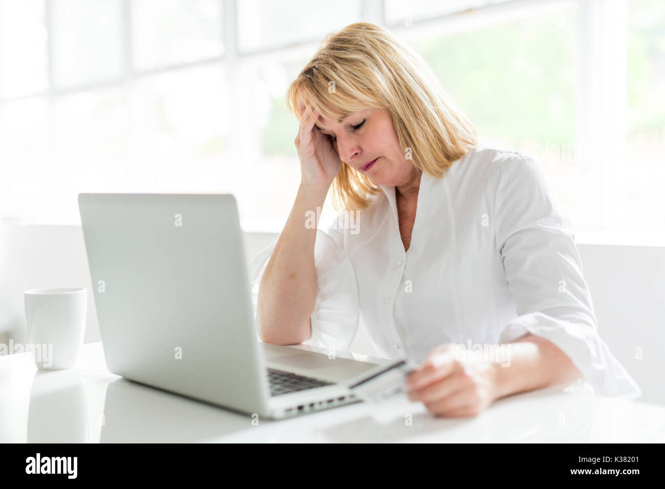 mature woman using laptop at home Stock Photo